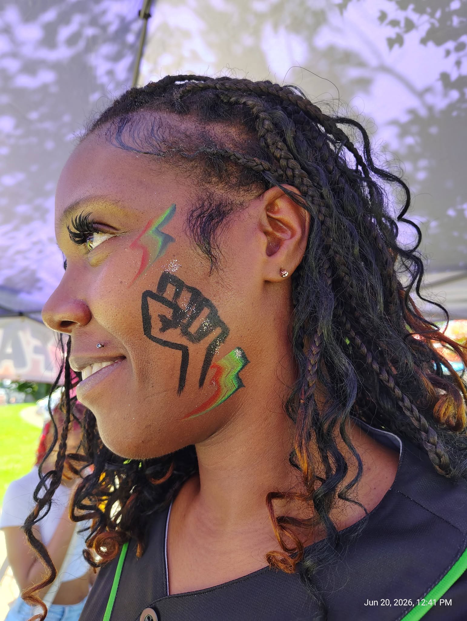 Woman with a bold lightning bolt face painting design