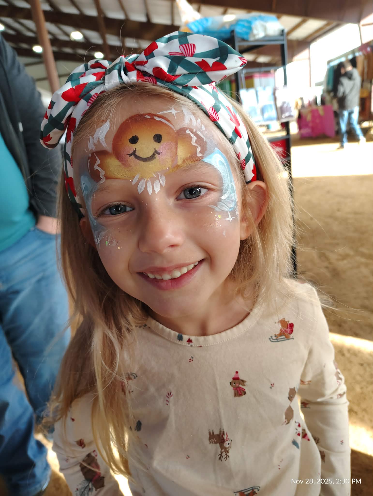Girl with a rose cheek design at a birthday party