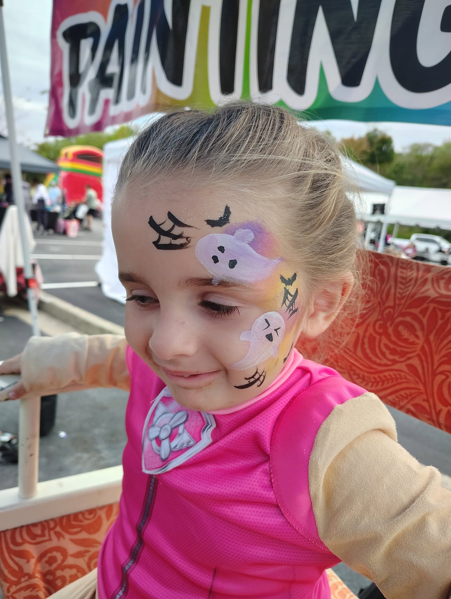 Girl with a Halloween ghost face painting design