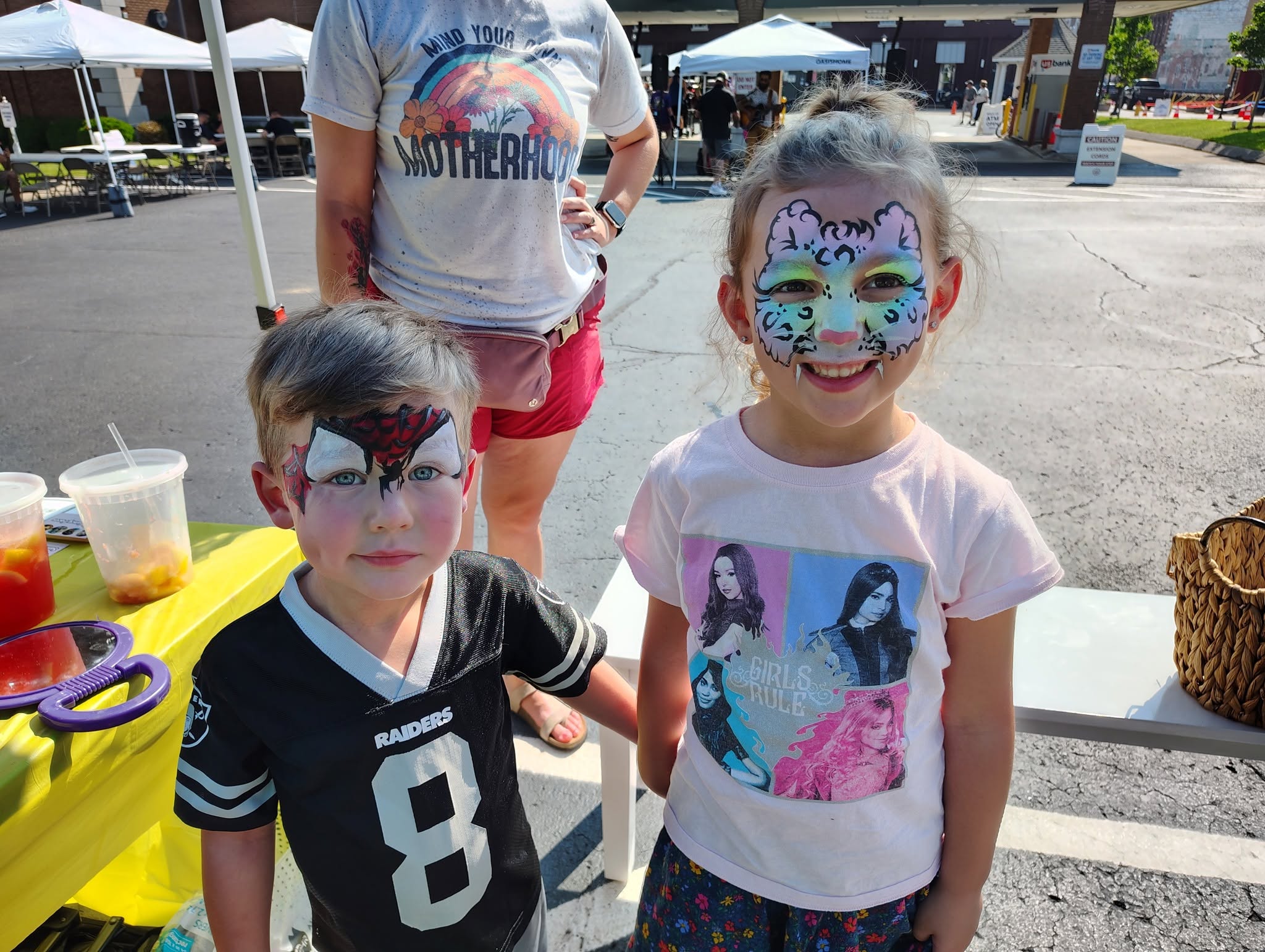 Girl with a leopard mask and boy with a Spider-Man mask