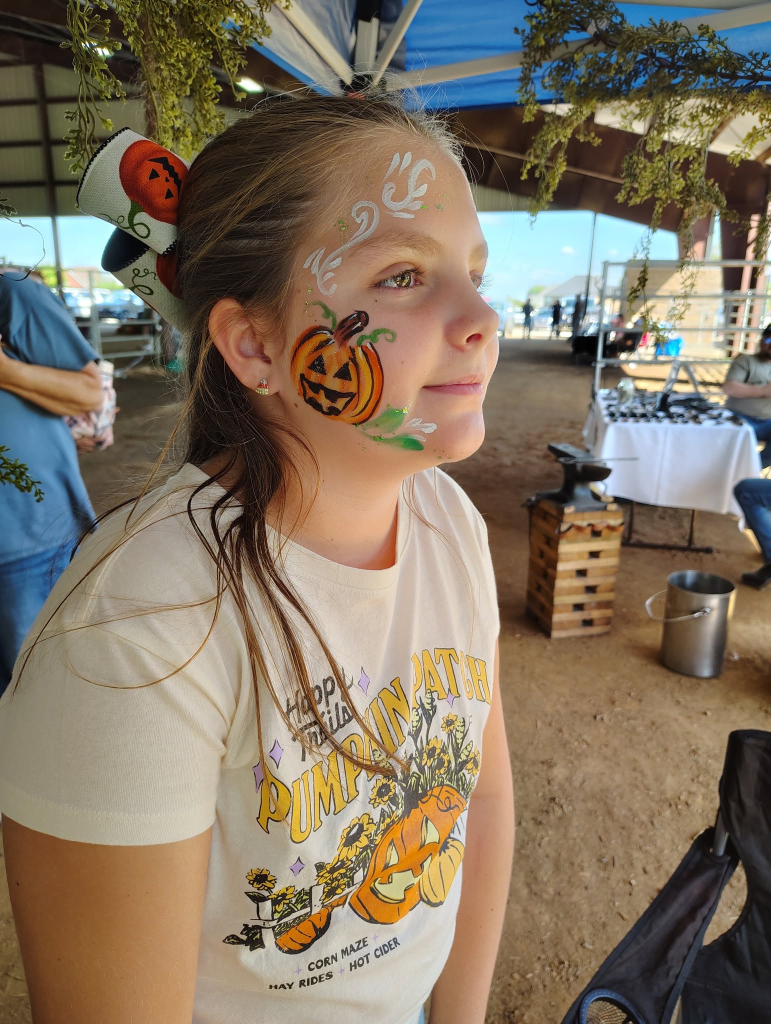 Girl with a pumpkin face painting design