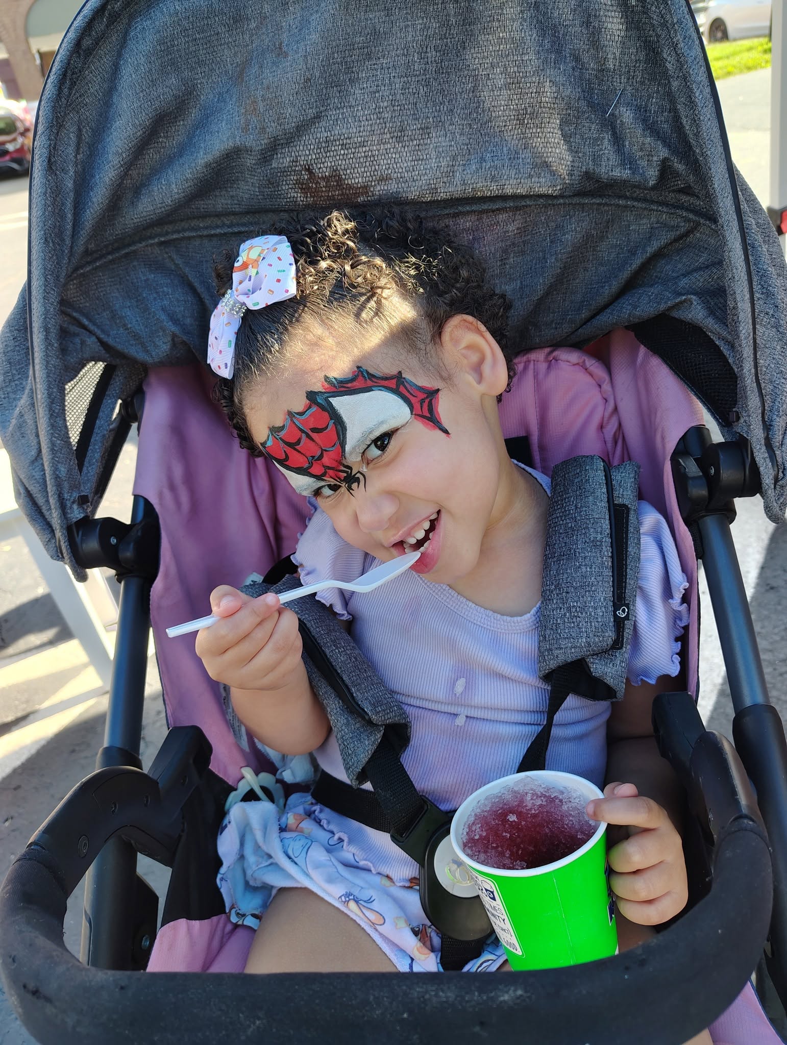 Toddler with a Spider-Man face painting design