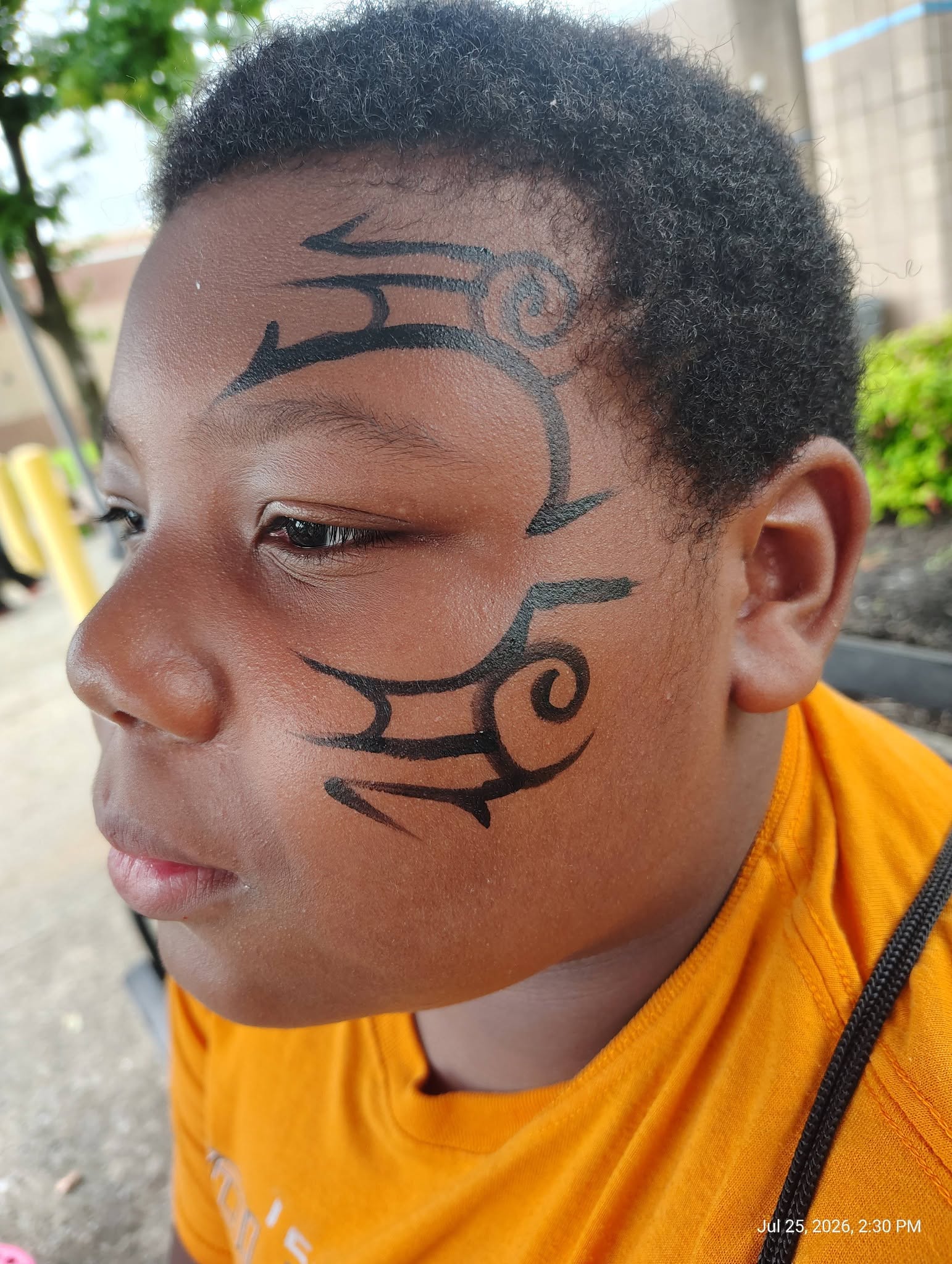 Boy with a tribal pattern face painting design