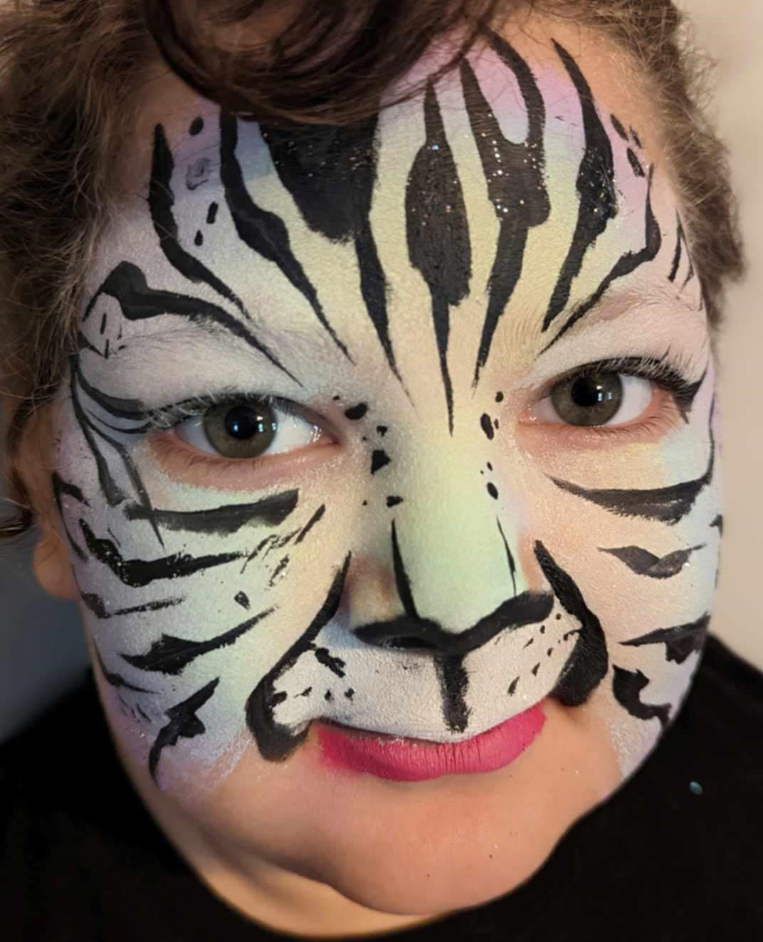 Child with a full-face white tiger design