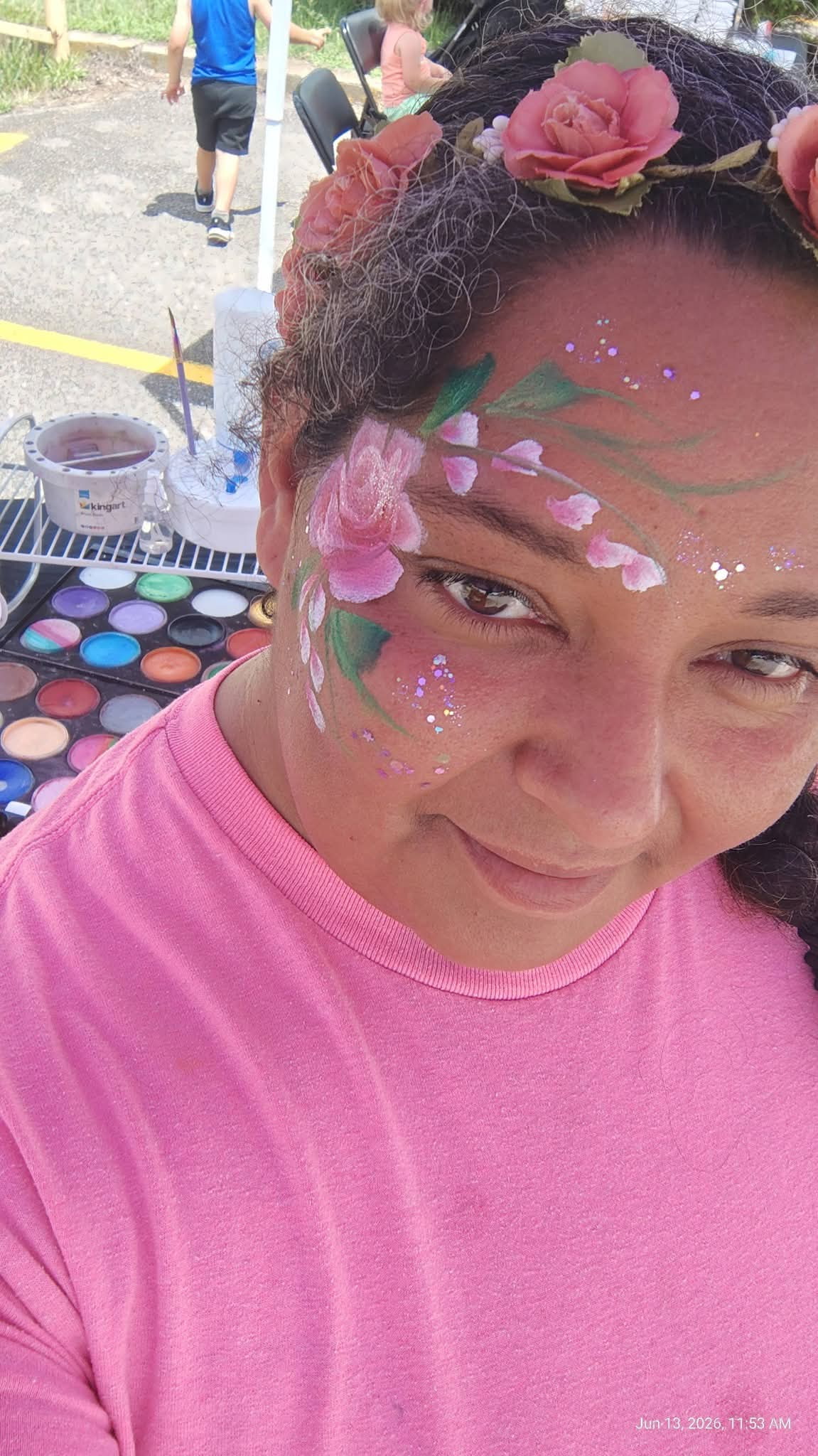 Sandra with a rose face painting design at an event